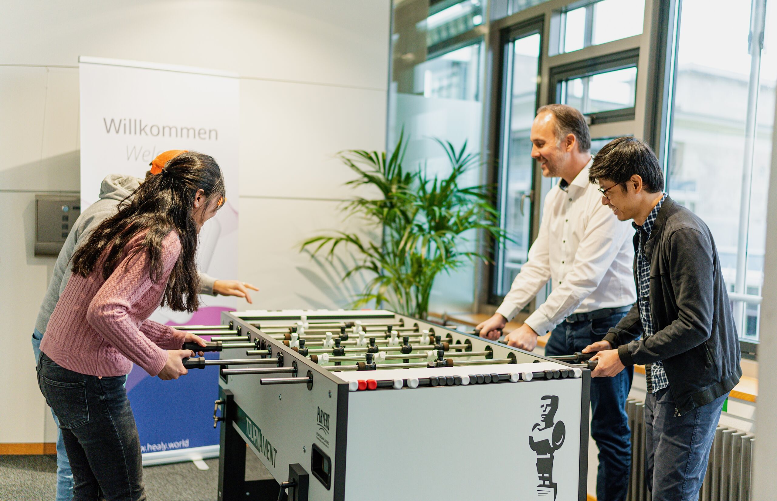 Healy World team enjoying a team table football game